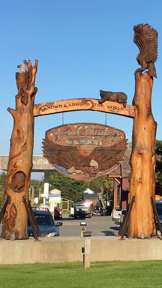 The carved Jay Country Store sign, with wooden eagles and the words Known Around the World